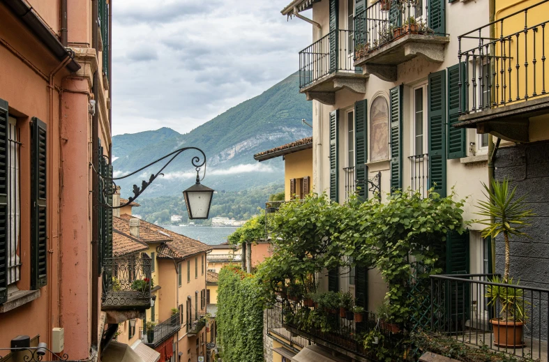 buildings and bushes, on both sides of a street with the mountain in the background