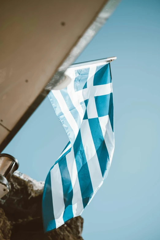 a greek flag is seen waving on a boat