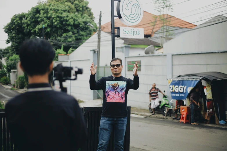 man with a picture of an unknown character holding up a sign