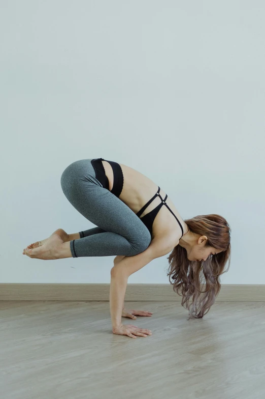 a young woman is posing on the floor