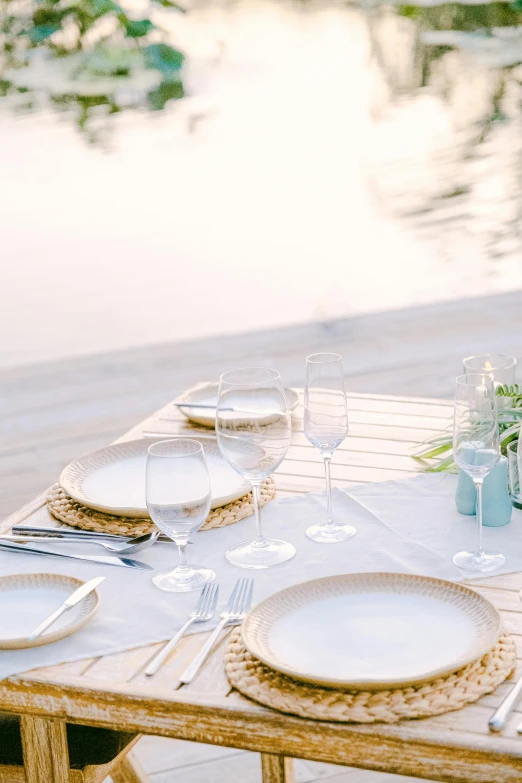 a table set with white plates and silverware