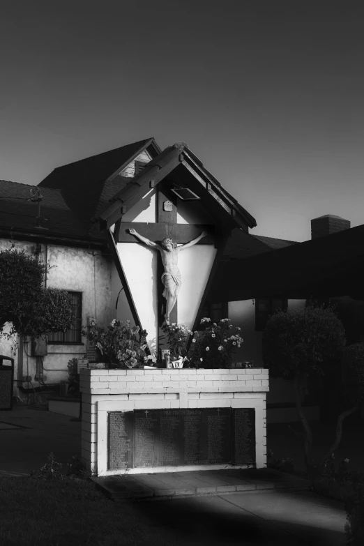 a building with a wooden crucifix in front of it