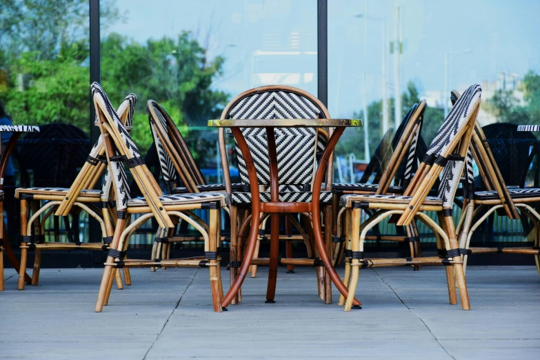 chairs and table sit in front of a window