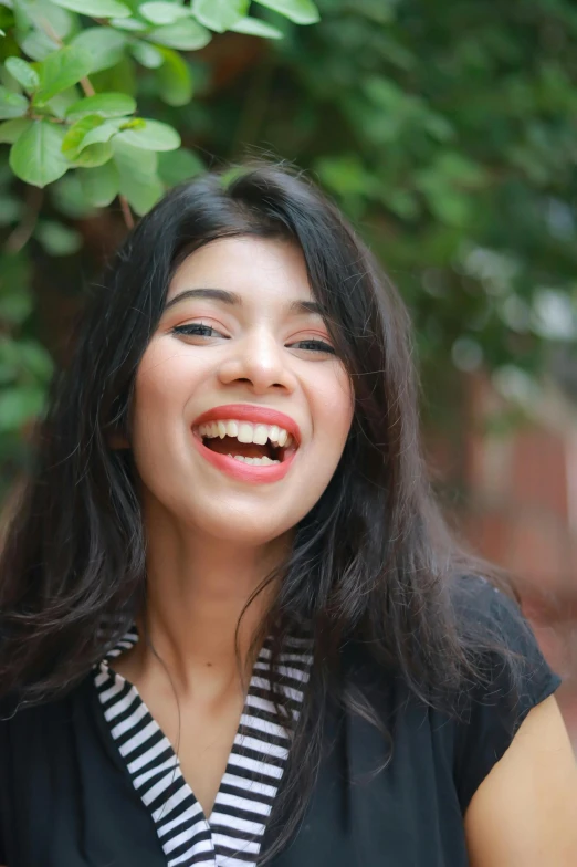 a woman smiles for the camera outside