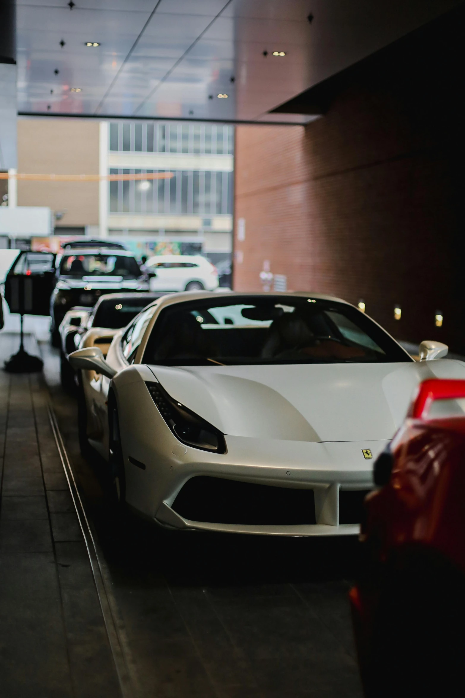 many parked cars are lined up in a building