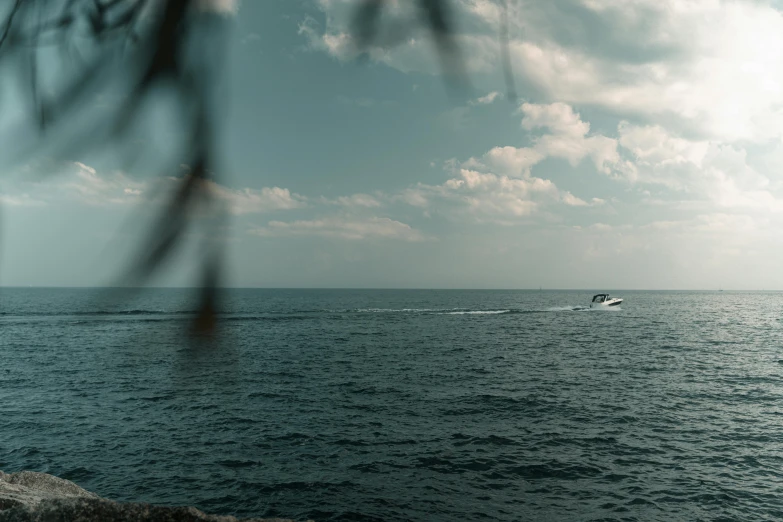 a small boat is speeding across the open water