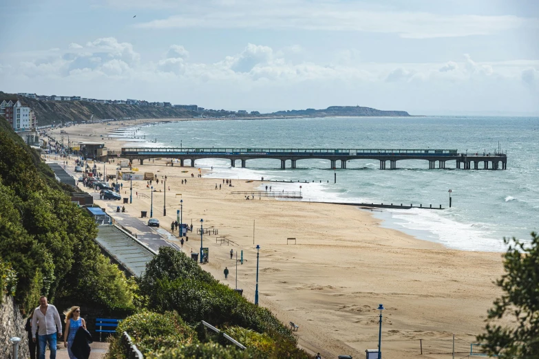 a boardwalk extends over a sandy beach toward the ocean