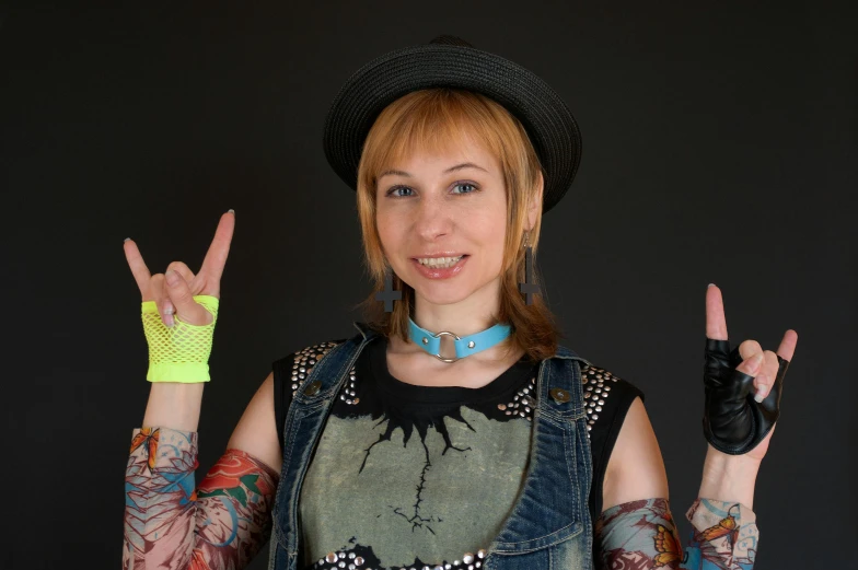 a woman wearing a hat and a peace sign