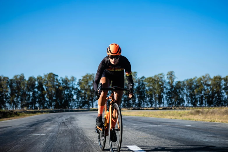 a man rides his bicycle down the middle of a road