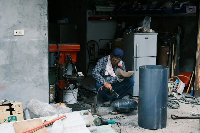 a man working on soing that he is looking at