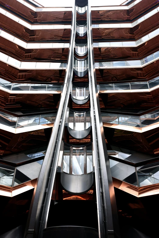 a metallic walkway going through a tall building