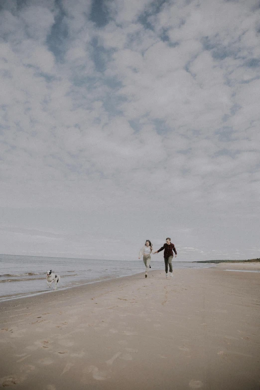 people are on the beach flying a kite