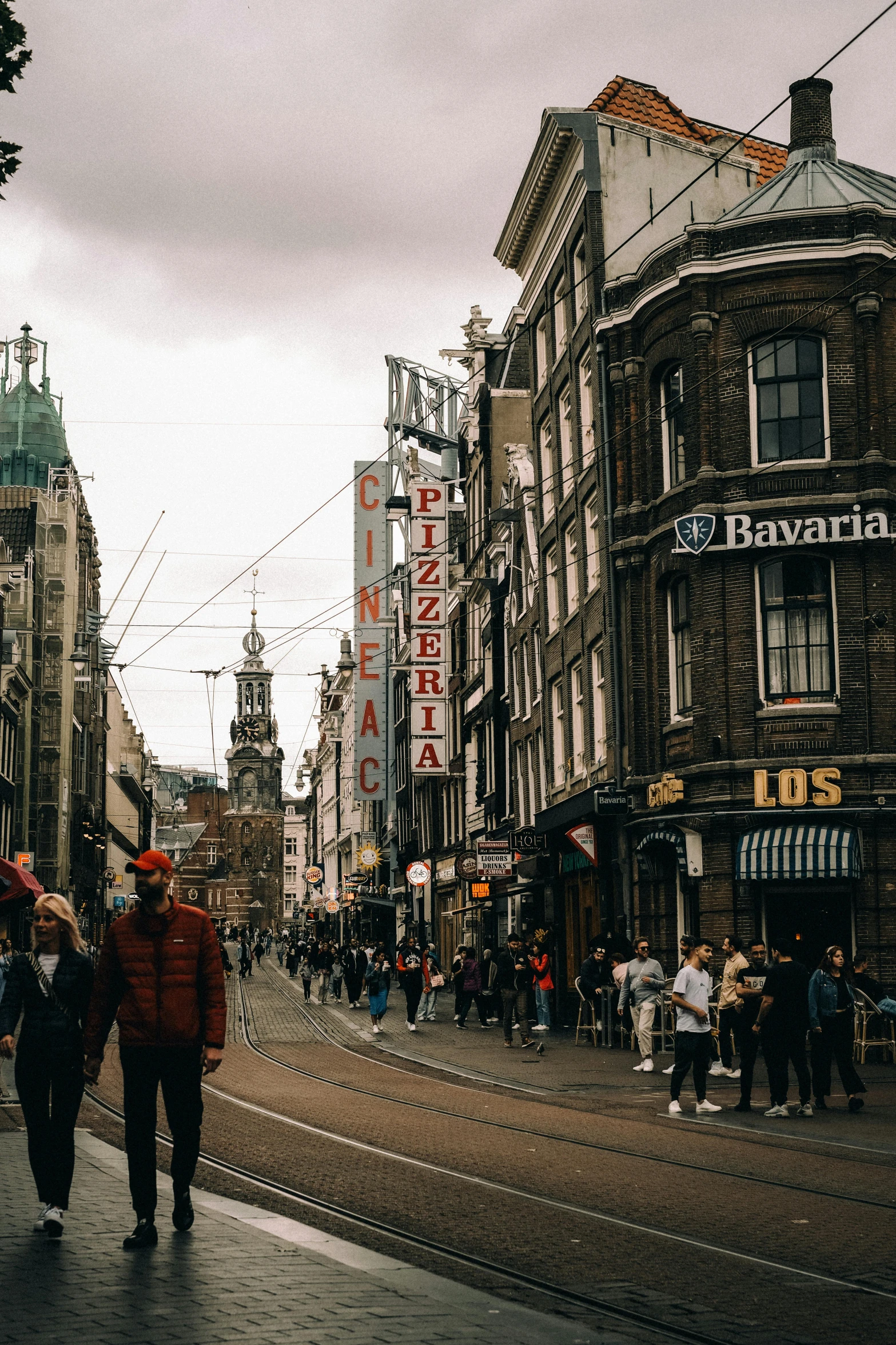 a man and woman walk down the street