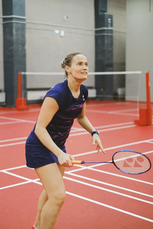 the woman is playing a game of tennis on the court