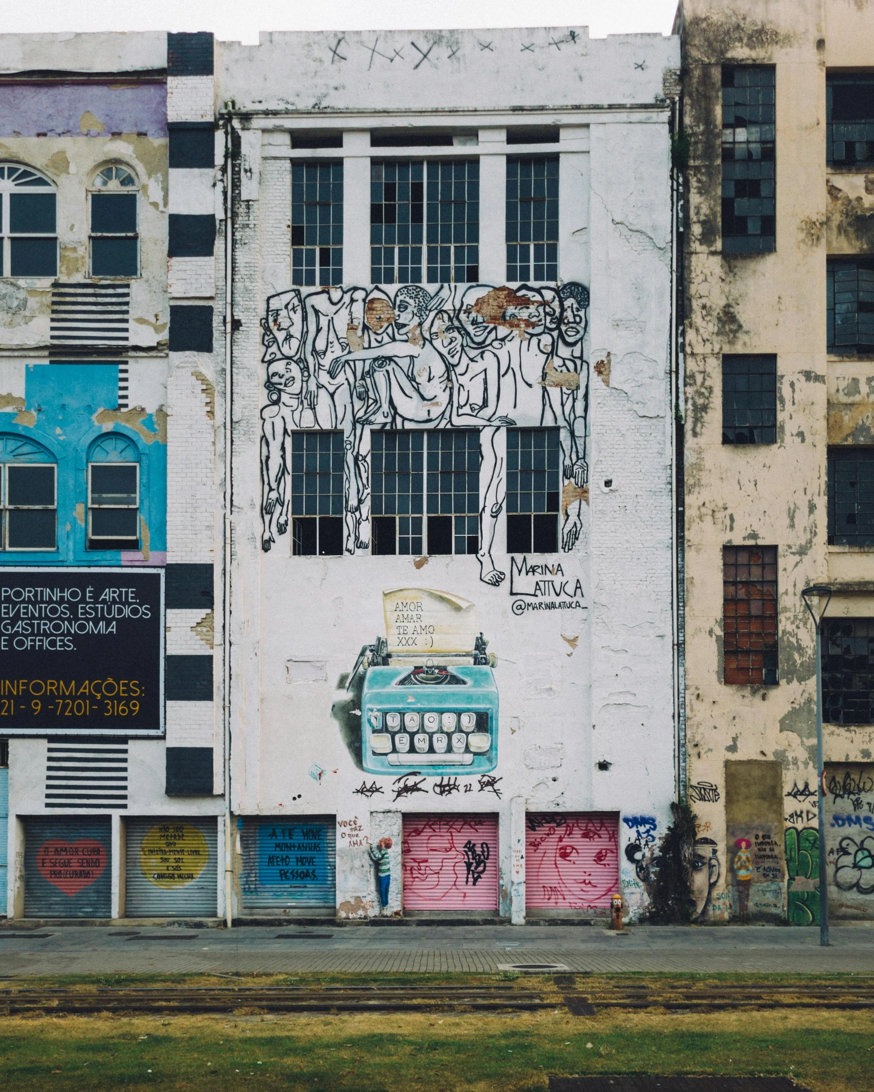 a large white building covered in colorful murals