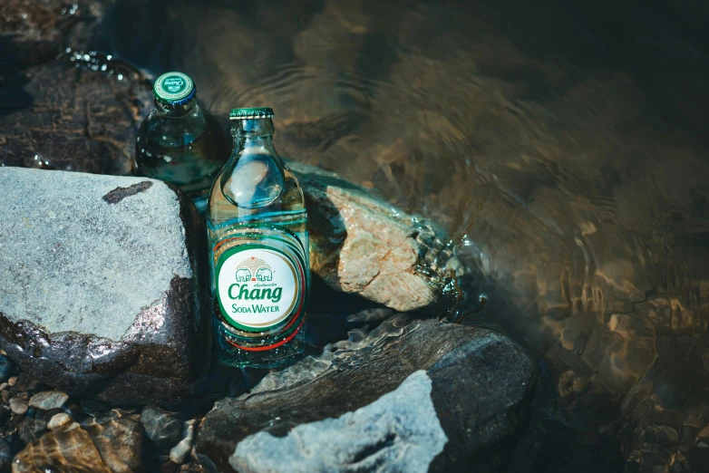 a bottle of caring is resting next to its box