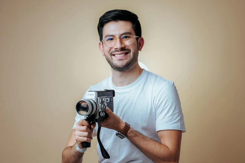 a man in white shirt holding a camera