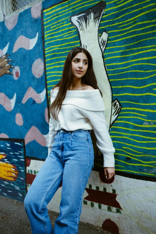 young woman in front of the ocean mural