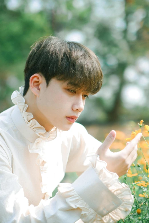 a boy that is in a field with flowers