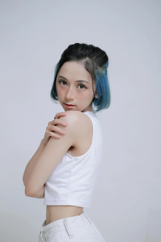 young lady with blue and green hair in white shirt