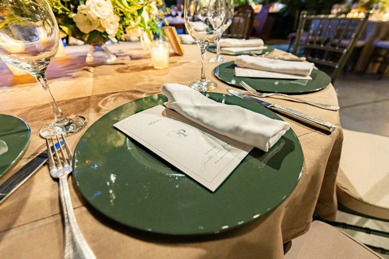 green and white plates with napkins set on them