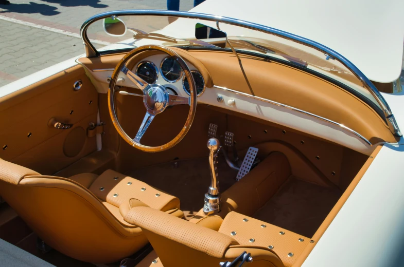 a tan convertible is shown with a chrome trim