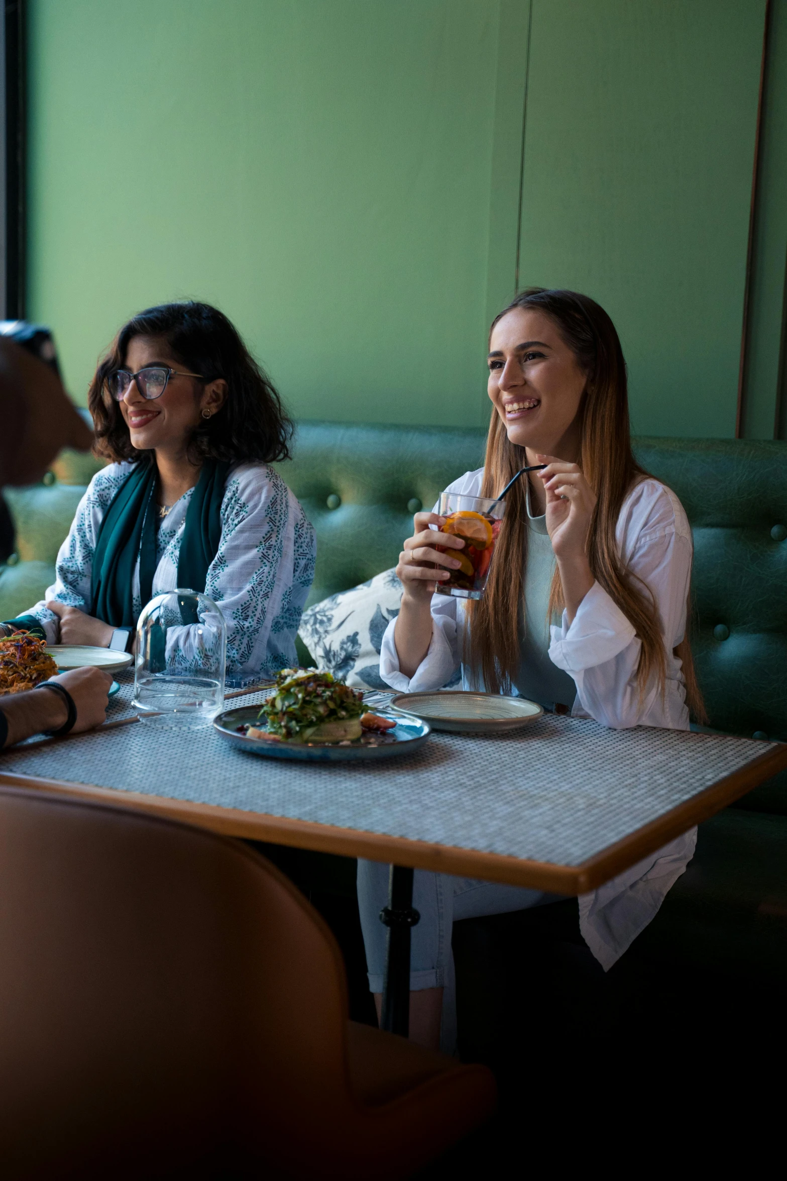 three women are having lunch in a restaurant