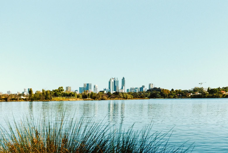 a lake in front of a city and skyline