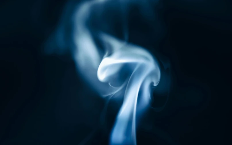 some smoke is flying through the air in a blue room