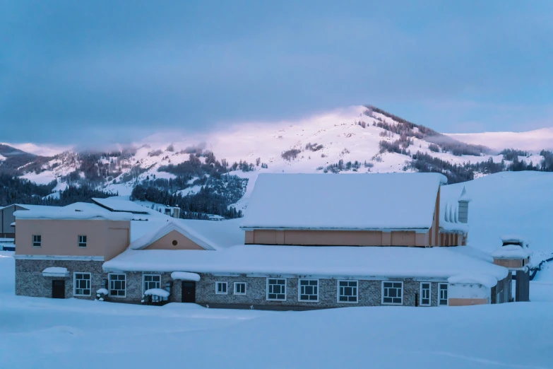 a church sitting in the middle of a snowy mountain