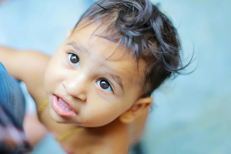 a young child with curly hair looking at the camera