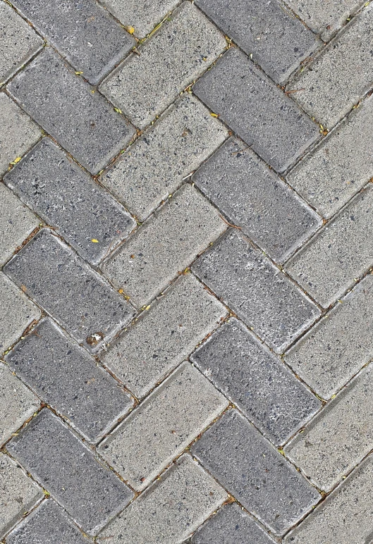 closeup of the pattern of an old, gray brick walkway