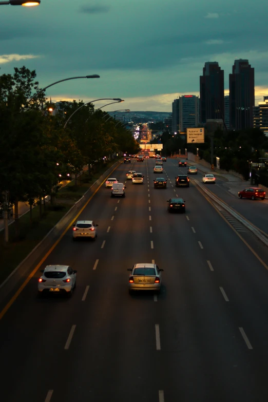 several cars are driving down a city street