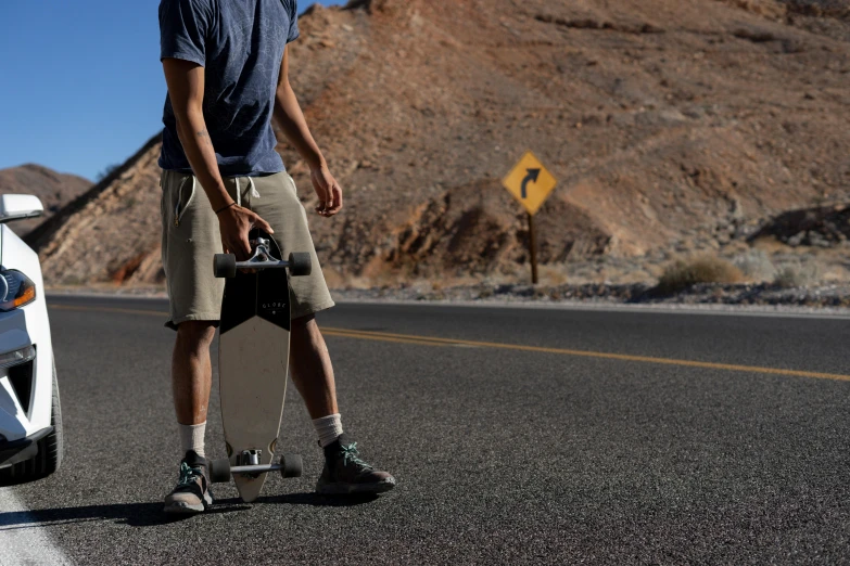 man walking away from his car on the road