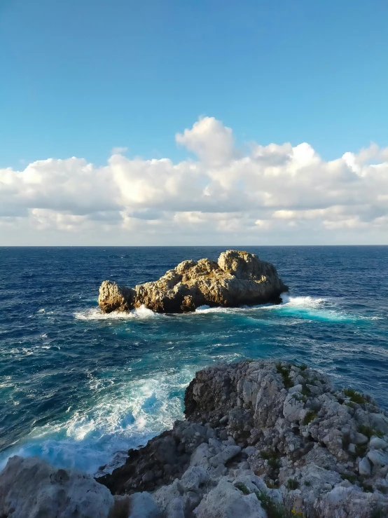 a large rock is in the middle of water