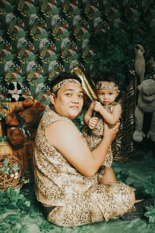 an asian woman with baby sitting in front of several teddy bears