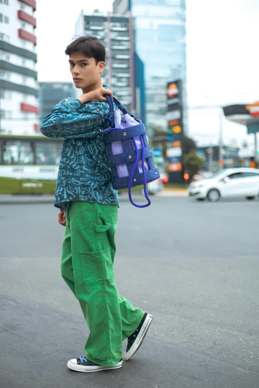 a man in green is carrying a blue handbag