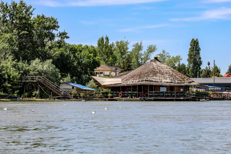 a boat floating on top of a lake next to houses