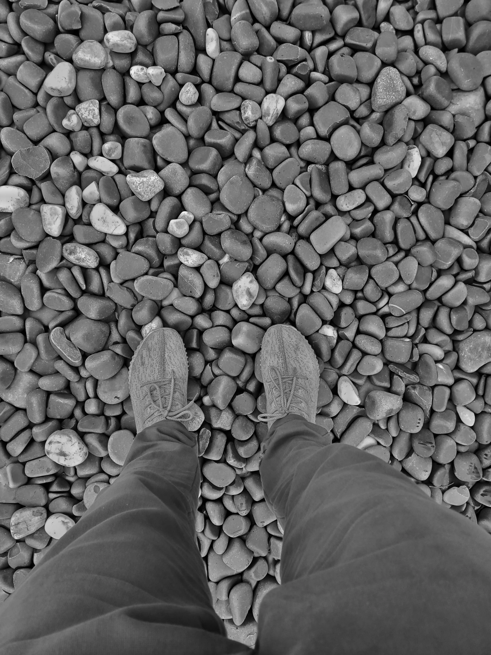 a person standing on top of a rock covered ground