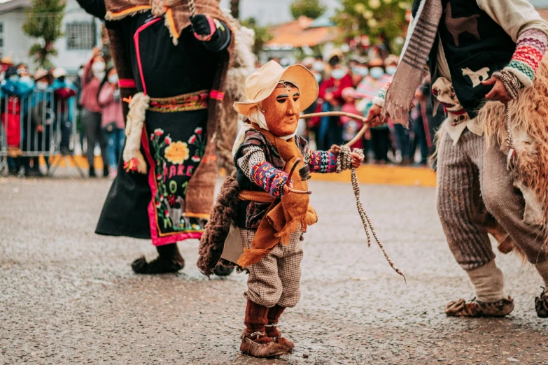 an native american  at the carnival holding on to his stick