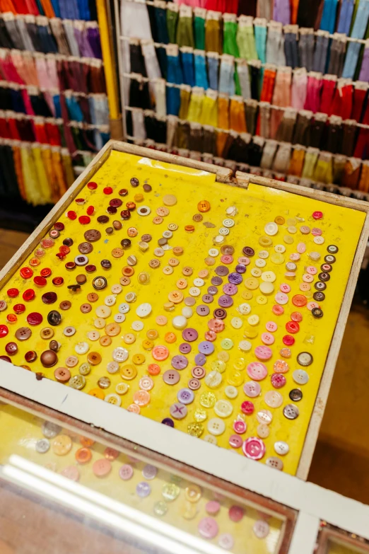 an assortment of ons and sewing pins sit in a shop