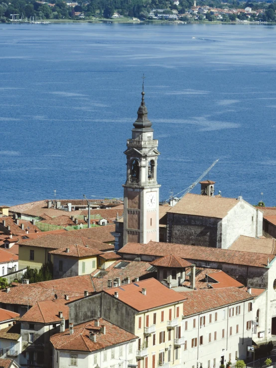 the city has red roof tops and a water view