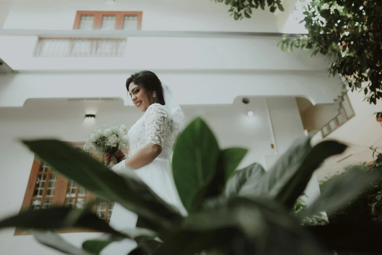 a woman is walking in front of some plants