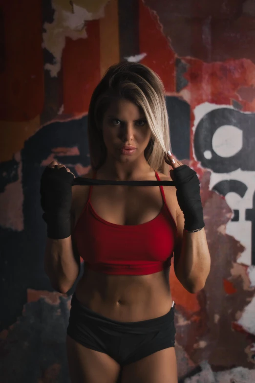 a women who is wearing black and red in a gym