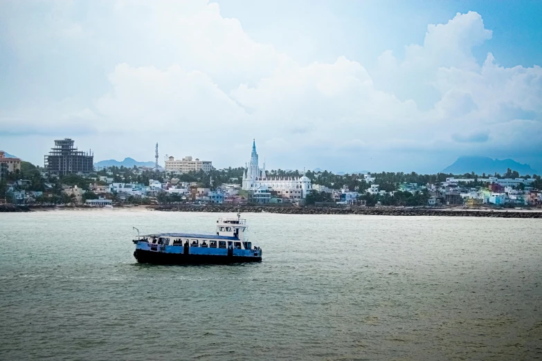 a small boat sits on the water by some buildings