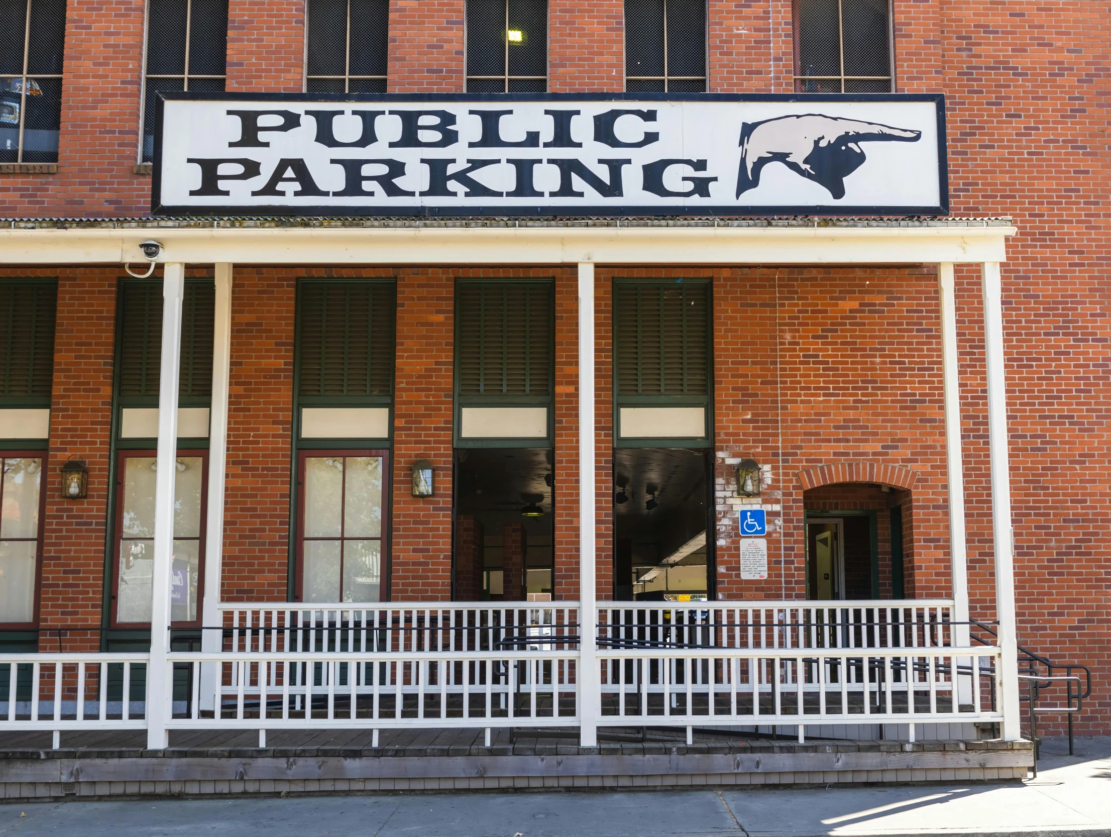 a brick building has a large sign that says public parking