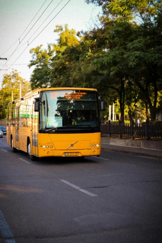 the city bus is coming down the street