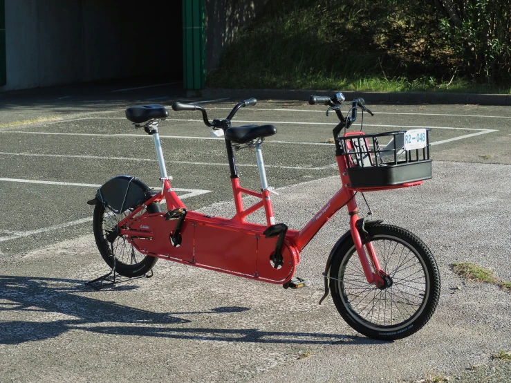 a red bike with black tires parked in a parking lot