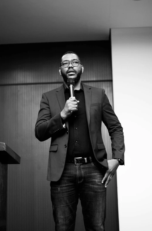 a man is standing in front of a microphone