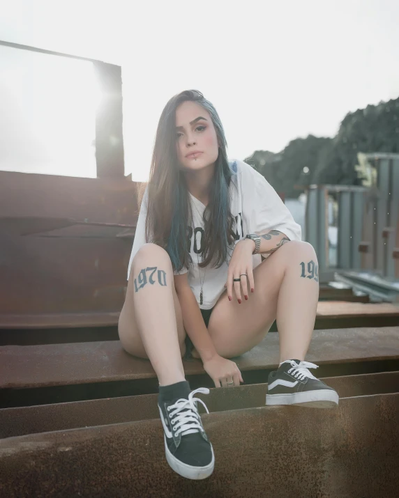 a girl sitting down with her knees crossed